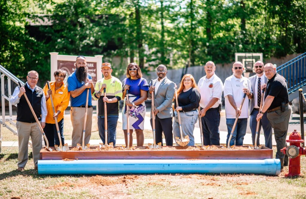 Group photo of Town of Ranlo officials, Congressman Tim Moore, and community members gathered for the South Ranlo Waterline Project groundbreaking ceremony at Gardin Park, May 4, 2026